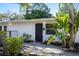 Inviting home entrance featuring lush landscaping with tropical plants at 2213 Wason Rd, Sarasota, FL 34231