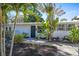 Charming home featuring a beautifully landscaped front yard with tropical plants at 2213 Wason Rd, Sarasota, FL 34231