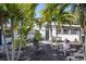 Charming home with well-manicured front yard featuring mature palm trees and outdoor seating at 2213 Wason Rd, Sarasota, FL 34231