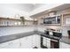 Well-organized kitchen featuring open shelving, subway tile backsplash, and granite countertops for a modern and functional space at 2213 Wason Rd, Sarasota, FL 34231