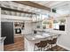 Bright kitchen with beamed ceilings, an island with seating, and stainless steel appliances for a modern, airy feel at 2213 Wason Rd, Sarasota, FL 34231
