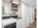Convenient laundry room with shelving, washer, dryer, and sliding door for efficient space utilization at 2213 Wason Rd, Sarasota, FL 34231