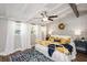 Bright main bedroom with a white iron bed frame, floral comforter, brick wall, and wood floors for a cozy, inviting retreat at 2213 Wason Rd, Sarasota, FL 34231