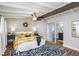 Inviting main bedroom with a white iron bed frame, floral comforter, brick wall, wood floors and ensuite bathroom at 2213 Wason Rd, Sarasota, FL 34231