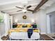 Cozy main bedroom featuring a white iron bed frame, a bright floral comforter, and wood floors for a warm and inviting ambiance at 2213 Wason Rd, Sarasota, FL 34231