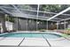 Secluded screened-in pool provides a private oasis, featuring tranquil water and surrounding foliage for a serene atmosphere at 2213 Wason Rd, Sarasota, FL 34231