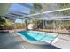 Inviting screened-in pool area offers a serene retreat, perfect for relaxation and recreation at 2213 Wason Rd, Sarasota, FL 34231