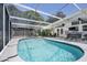 Relaxing screened-in pool features ample seating and an adjacent backyard, ideal for leisure and entertaining guests at 2213 Wason Rd, Sarasota, FL 34231
