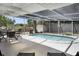 Secluded screened-in pool complemented by shaded seating and a well-maintained yard, perfect for relaxation and leisure at 2213 Wason Rd, Sarasota, FL 34231