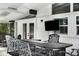 Covered patio with outdoor TV and dining area, overlooks the screened-in pool for the ultimate entertainment experience at 2213 Wason Rd, Sarasota, FL 34231
