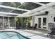 Elegant screened-in pool area with lounge and dining seating, offering seamless indoor-outdoor living and relaxation at 2213 Wason Rd, Sarasota, FL 34231