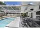 Stylish screened-in pool patio complete with a bar and ample seating, perfect for entertaining and relaxing poolside at 2213 Wason Rd, Sarasota, FL 34231