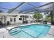 Inviting screened-in pool area with clear blue water and shaded seating, perfect for relaxation and outdoor entertainment at 2213 Wason Rd, Sarasota, FL 34231