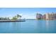 Waterfront view of a luxury high-rise building with manicured grounds at 2213 Wason Rd, Sarasota, FL 34231