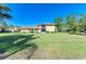 Backyard featuring the two story home, a screened in balcony, and lush green grass at 2233 Beneva Ter # 2232, Sarasota, FL 34232