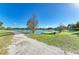 Backyard view of the tranquil lake with a boat on the shore at 2233 Beneva Ter # 2232, Sarasota, FL 34232