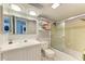 Clean bathroom featuring shower, sink, toilet, mirror, and shelves for towels at 2233 Beneva Ter # 2232, Sarasota, FL 34232