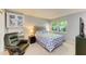 Comfortable bedroom with a patterned bedspread, natural light, and a cozy reading chair at 2233 Beneva Ter # 2232, Sarasota, FL 34232