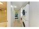 Hallway with bathroom, laundry area featuring a stacked washer and dryer, and bedroom at 2233 Beneva Ter # 2232, Sarasota, FL 34232