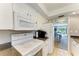 Well-equipped kitchen with microwave, stove, and a view into the adjacent living area at 2233 Beneva Ter # 2232, Sarasota, FL 34232