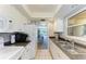 Functional kitchen featuring a double sink, white cabinetry, and access to other living spaces at 2233 Beneva Ter # 2232, Sarasota, FL 34232