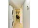Hall laundry area featuring a stacked washer and dryer with access to another room at 2233 Beneva Ter # 2232, Sarasota, FL 34232