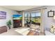 This living room has a view of the screened patio, lake, fireplace, and access to natural light at 2233 Beneva Ter # 2232, Sarasota, FL 34232