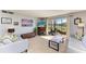 Comfortable living room with fireplace, sliding glass doors, and view of screened patio and community lake at 2233 Beneva Ter # 2232, Sarasota, FL 34232