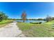 Large pond with a walking path next to it and a floating green dock at 2233 Beneva Ter # 2232, Sarasota, FL 34232
