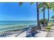 Tranquil waterfront view featuring bench seating under palm trees overlooking the beautiful ocean and bridge at 2233 Beneva Ter # 2232, Sarasota, FL 34232