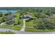 Beautiful home with lush landscaping and mature trees, long driveways, and surrounded by water at 22354 Panther Loop, Bradenton, FL 34202
