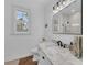 Bathroom with white shiplap walls, marble counters, and a window with shutters at 22354 Panther Loop, Bradenton, FL 34202