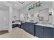 Elegant bathroom features dual sinks, navy blue cabinets, and a shower with bench at 22354 Panther Loop, Bradenton, FL 34202
