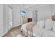 Bright and serene bedroom featuring a plush bed, wood floors, and natural light at 22354 Panther Loop, Bradenton, FL 34202