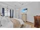 Cozy bedroom features a tray ceiling, plenty of natural light, and coastal decor at 22354 Panther Loop, Bradenton, FL 34202