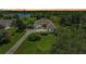 Stunning lakefront home featuring lush landscaping and a sprawling green lawn with a circular driveway at 22354 Panther Loop, Bradenton, FL 34202