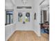 Bright foyer featuring white wainscoting, a double door entry, and wood floors at 22354 Panther Loop, Bradenton, FL 34202