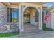 Inviting stone facade entrance with black shutters, brick steps, and an American flag waving at 22354 Panther Loop, Bradenton, FL 34202