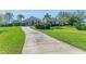Inviting home with mature landscaping, a well-manicured lawn, and a winding driveway for added curb appeal at 22354 Panther Loop, Bradenton, FL 34202