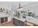 Island kitchen boasts a granite countertop, custom cabinets, and a view into the living space at 22354 Panther Loop, Bradenton, FL 34202