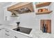 Gourmet kitchen showcasing custom range hood, open shelving, and modern electric cooktop at 22354 Panther Loop, Bradenton, FL 34202