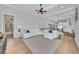 Open-concept living area boasts a large white sofa, wood flooring, and access to the kitchen at 22354 Panther Loop, Bradenton, FL 34202