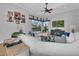Comfortable living room with a plush white sectional, view of the screened-in pool, and modern decor at 22354 Panther Loop, Bradenton, FL 34202