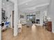 Open living room with high ceilings, fireplace, hardwood floors, and access to outdoor space at 22354 Panther Loop, Bradenton, FL 34202