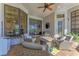 Relaxing screened-in patio features brick floors, outdoor seating and a ceiling fan at 22354 Panther Loop, Bradenton, FL 34202