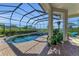 Inviting screened-in pool area with a brick paver deck, a stone hot tub, and lush landscaping for privacy and relaxation at 22354 Panther Loop, Bradenton, FL 34202