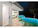 Lit balcony at night offers views into the adjacent bedroom with views of the surroundings at 2327 Hillview St, Sarasota, FL 34239
