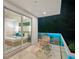 Outdoor balcony at night featuring seating and lit glass railings looking into the bedroom at 2327 Hillview St, Sarasota, FL 34239