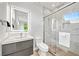 Contemporary bathroom features a walk-in shower with glass door and floating vanity sink at 2327 Hillview St, Sarasota, FL 34239