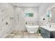 Spa-like bathroom features soaking tub, walk-in shower, and modern vanity with designer fixtures at 2327 Hillview St, Sarasota, FL 34239